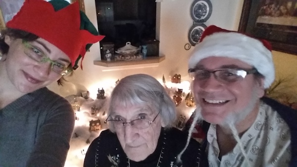 Eula, Doug, and Megan in front of Mom's Christmas Village, 2016