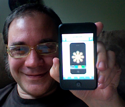 An SVG rendering of an iPhone, with the SVG Logo, displayed on an iPod Touch, held aloft by a smiling Shepazu.